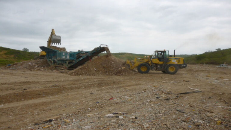 Planta de trituración de escombros en la escombrera La Solita, con excavadora y cargadora en operación